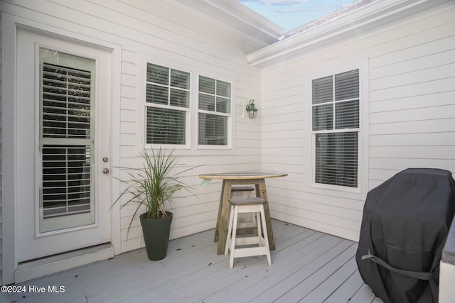 wooden deck with a grill