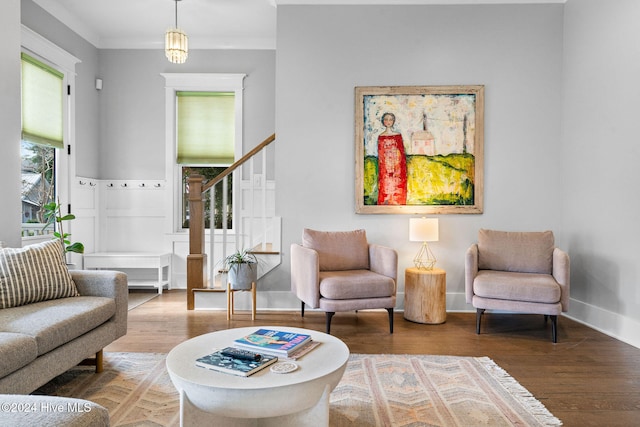 living room with hardwood / wood-style floors and ornamental molding