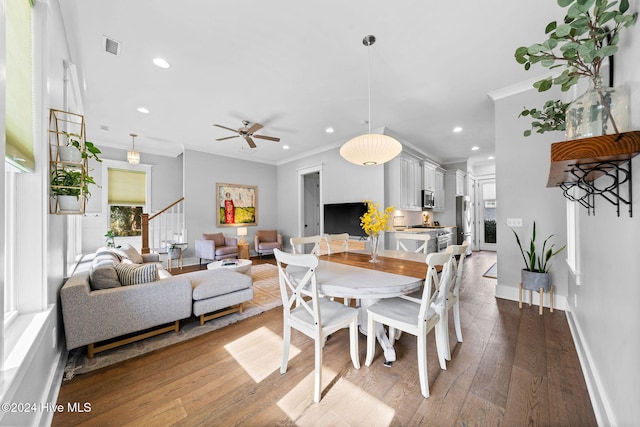 dining area featuring hardwood / wood-style floors, ceiling fan, and ornamental molding