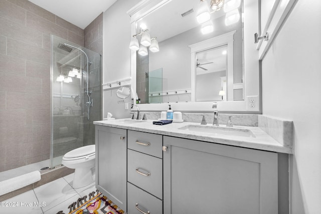 bathroom featuring ceiling fan, vanity, an enclosed shower, and toilet