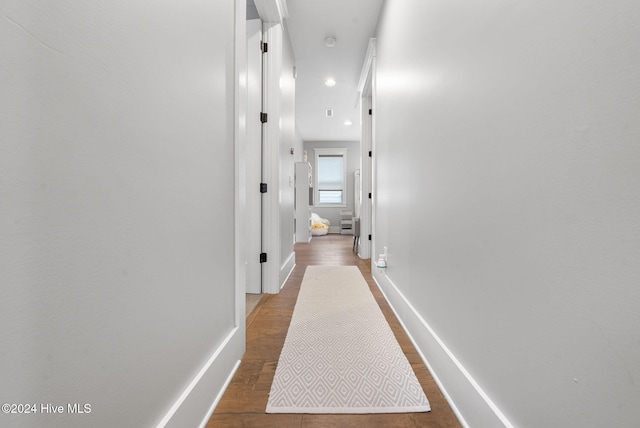 corridor featuring wood-type flooring