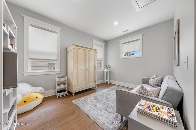 living area with hardwood / wood-style flooring