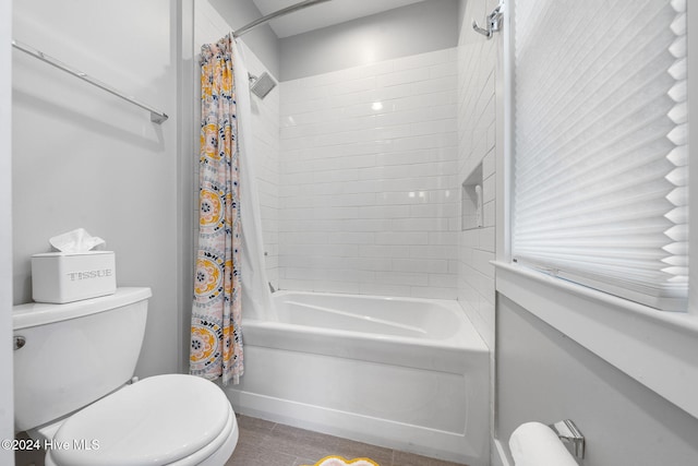 bathroom with shower / bath combo with shower curtain and toilet