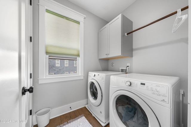 laundry area with cabinets, separate washer and dryer, and dark wood-type flooring