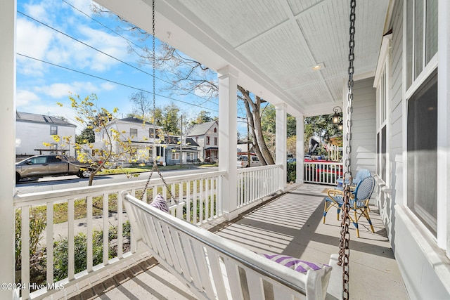 wooden terrace featuring covered porch