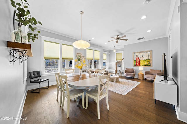 dining room featuring crown molding, ceiling fan, and dark hardwood / wood-style floors