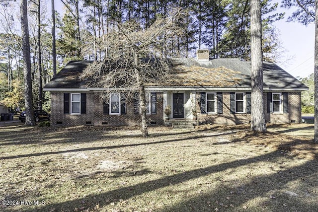 view of front of property with crawl space, brick siding, and a chimney