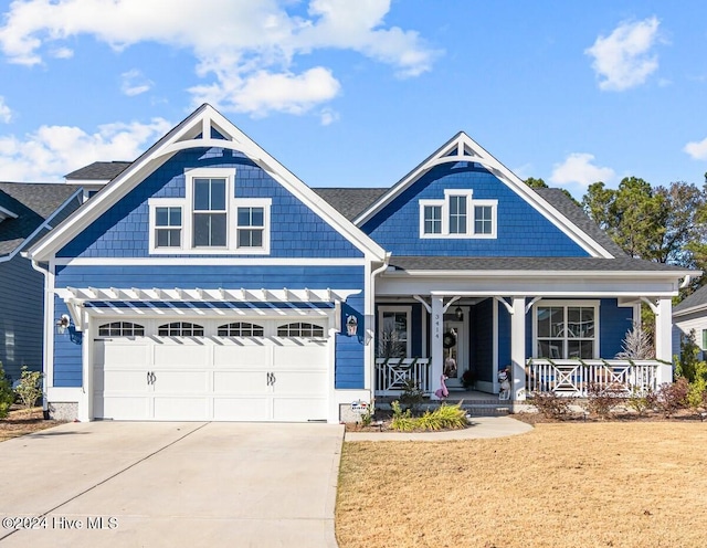 view of front of home with covered porch and a garage