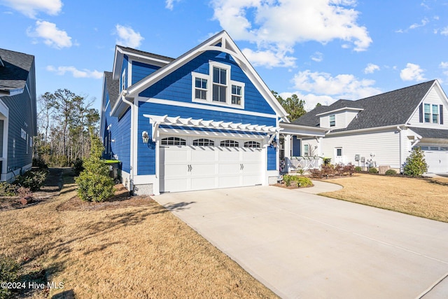 view of front of home featuring a front yard and a garage