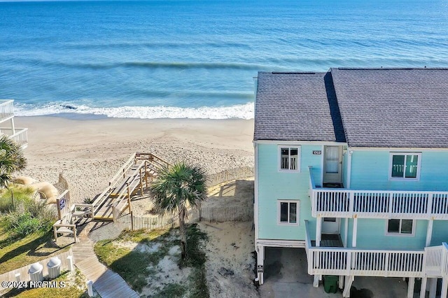 drone / aerial view with a water view and a view of the beach