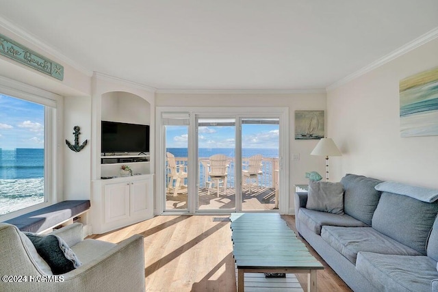 living room featuring a wealth of natural light, crown molding, and hardwood / wood-style flooring