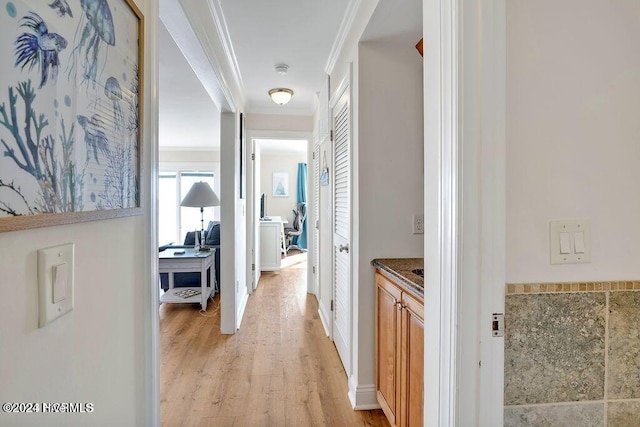 hall featuring light hardwood / wood-style floors and ornamental molding