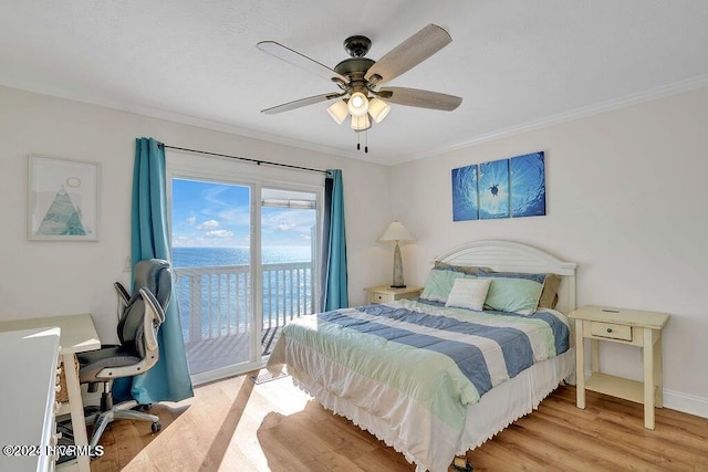 bedroom with access to exterior, light wood-type flooring, ceiling fan, crown molding, and a water view