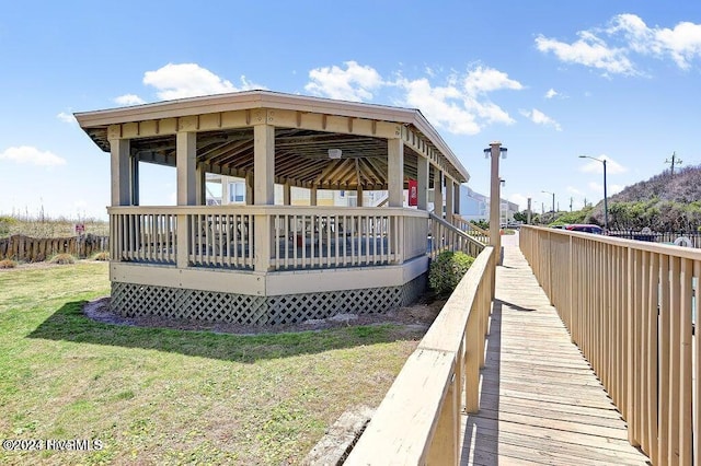 rear view of house featuring a gazebo and a lawn