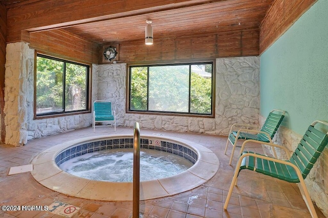 sitting room featuring wooden ceiling, a wealth of natural light, and a hot tub