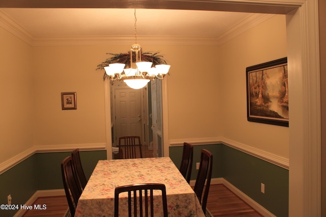 dining space with a chandelier, wood-type flooring, and ornamental molding