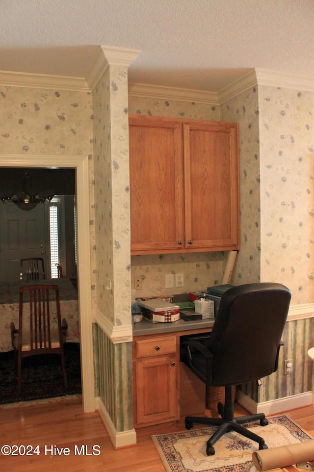 office with crown molding, a textured ceiling, and light wood-type flooring