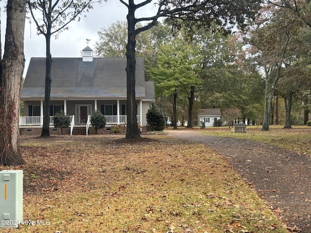 new england style home featuring covered porch