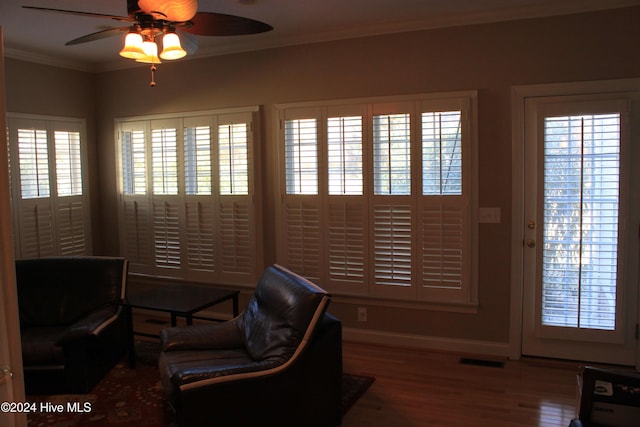 home office with ceiling fan, wood-type flooring, and ornamental molding