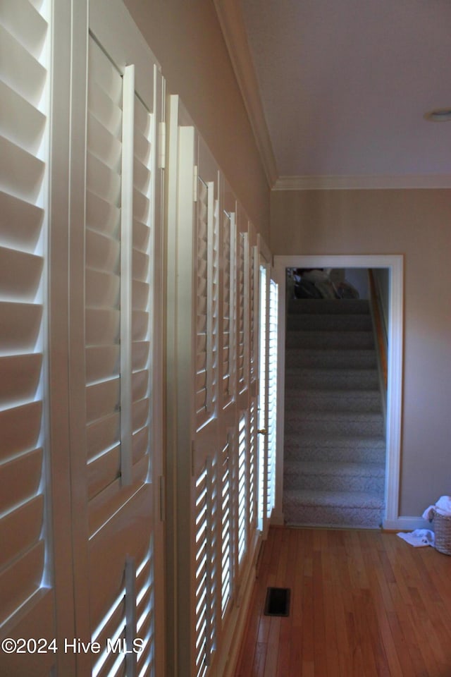 hallway featuring crown molding and hardwood / wood-style flooring