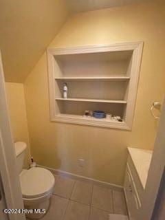 bathroom with tile patterned flooring, vanity, and toilet