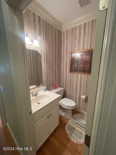 bathroom featuring crown molding, vanity, and toilet