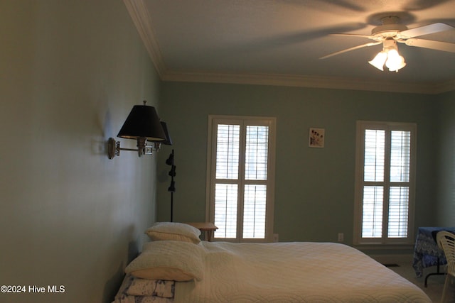 bedroom with ceiling fan and crown molding