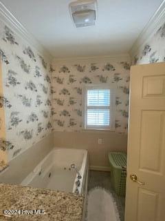 bathroom featuring a tub to relax in and ornamental molding