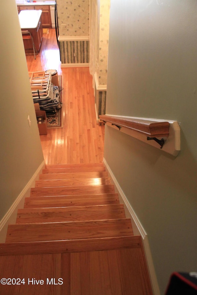 stairway featuring wood-type flooring