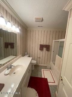 bathroom featuring vanity, toilet, ornamental molding, and walk in shower