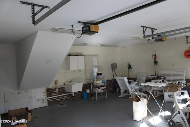 garage with sink and a garage door opener