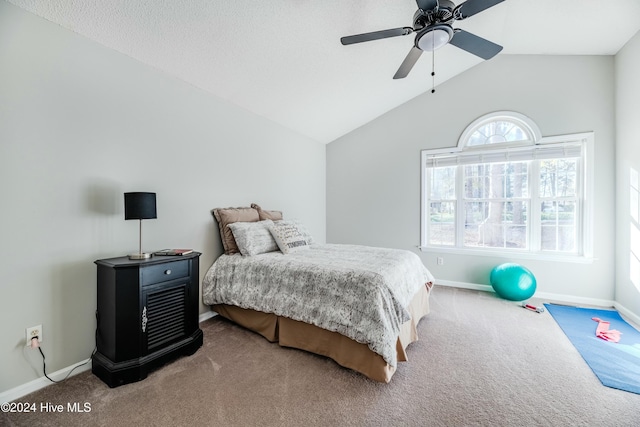 carpeted bedroom featuring ceiling fan and vaulted ceiling