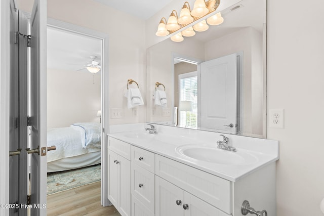 bathroom featuring wood-type flooring, vanity, and ceiling fan