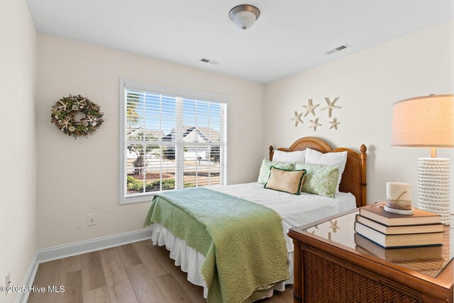 bedroom with hardwood / wood-style flooring