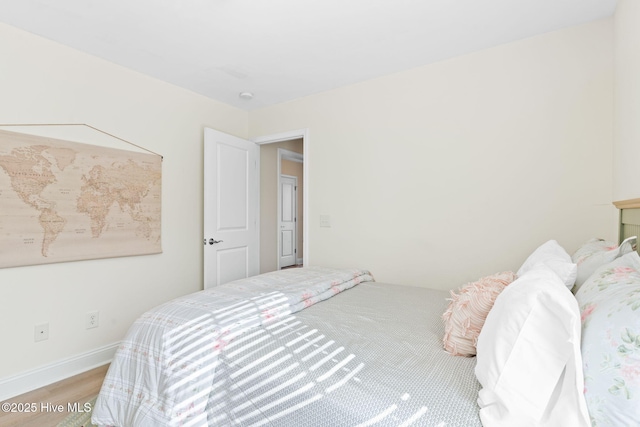 bedroom with wood-type flooring