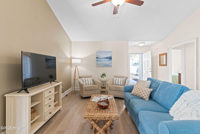 living room featuring vaulted ceiling, light hardwood / wood-style floors, and ceiling fan