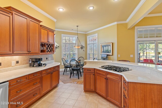 kitchen featuring tasteful backsplash, ornamental molding, appliances with stainless steel finishes, and decorative light fixtures