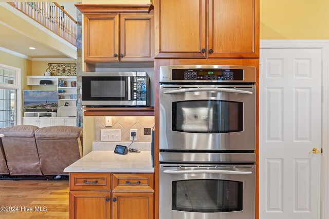 kitchen with sink, crown molding, light tile patterned floors, ceiling fan, and stainless steel appliances