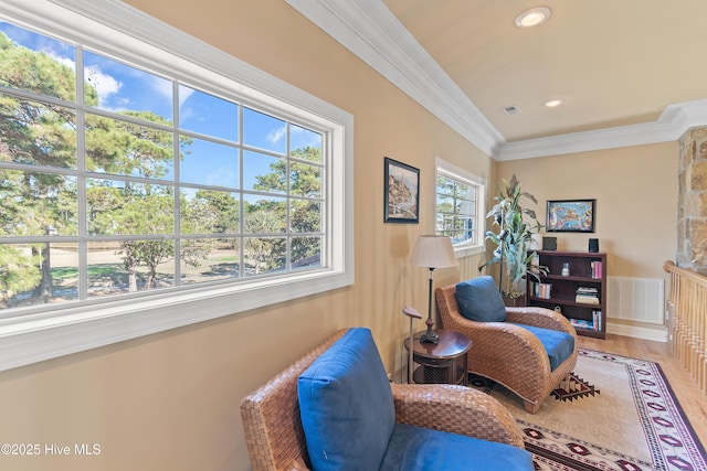 sitting room with visible vents, wood finished floors, recessed lighting, and ornamental molding