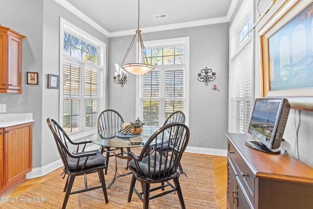 kitchen with a kitchen island, a fireplace, light hardwood / wood-style floors, crown molding, and built in shelves