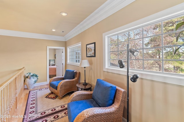 living area featuring recessed lighting, ornamental molding, wood finished floors, and plenty of natural light