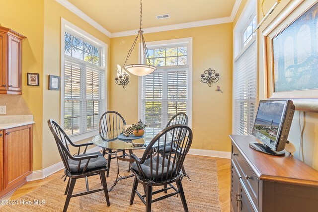 dining area featuring plenty of natural light and ornamental molding