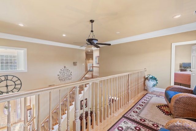 hallway with recessed lighting, wood finished floors, and crown molding