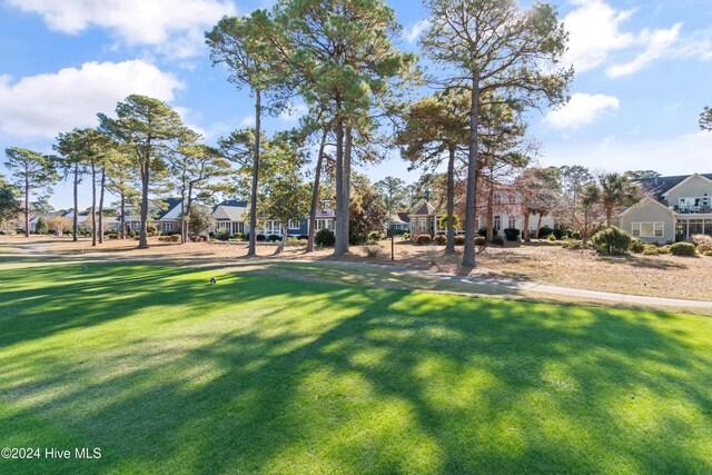 view of property's community with a lawn