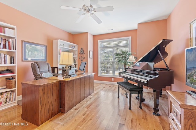 office with visible vents, light wood finished floors, baseboards, and ceiling fan