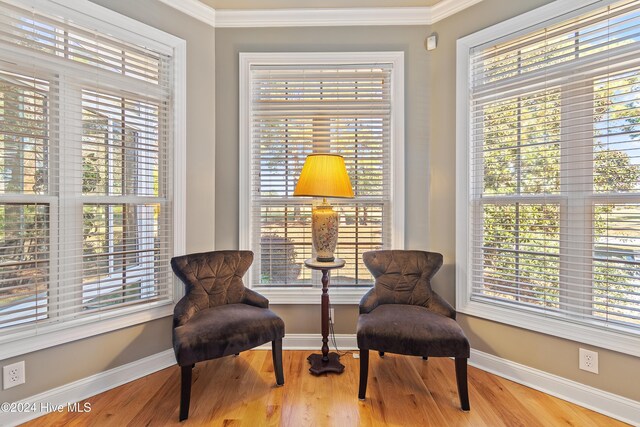 sitting room featuring crown molding and hardwood / wood-style floors