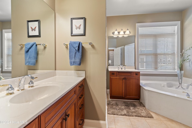 full bathroom with tile patterned flooring, two vanities, a sink, and a garden tub