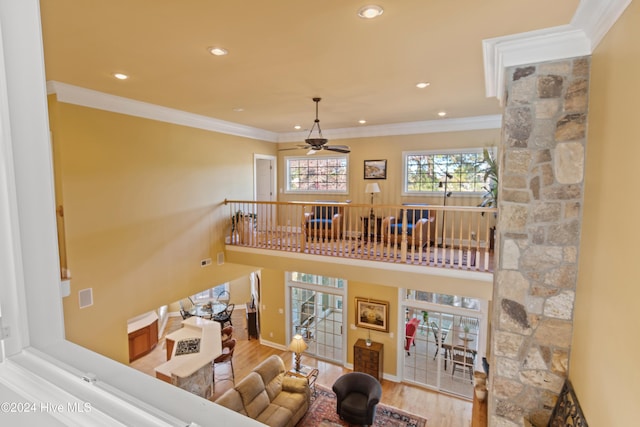 living room featuring crown molding, recessed lighting, ceiling fan, wood finished floors, and baseboards