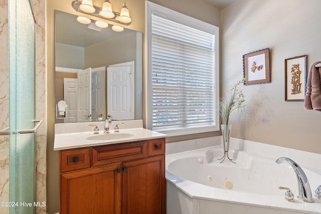 full bath with a whirlpool tub and vanity