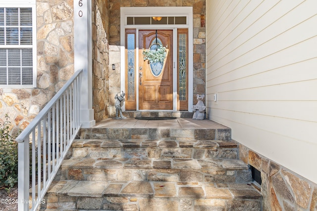 doorway to property featuring stone siding